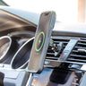 Image showing a side view of the Mighty Mount MagSafe Wireless Charger attached to a car's air vent. The charger, designed for MagSafe-compatible smartphones, appears sleek and compact, mounted securely at an angle that facilitates easy device attachment and viewing. The focus is on the mechanism of the mount and the vent slats, highlighting the integration and stability of the setup within the car's dashboard.